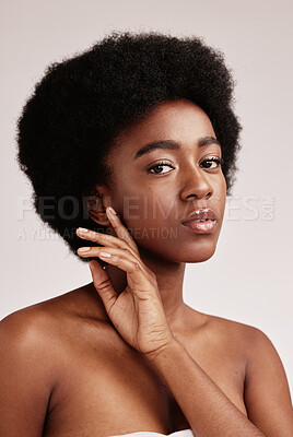 Buy stock photo Portrait, natural or skincare and a model black woman in studio on a gray background with afro hair. Skin, cosmetics and beauty with an attractive young female posing indoor for health or wellness