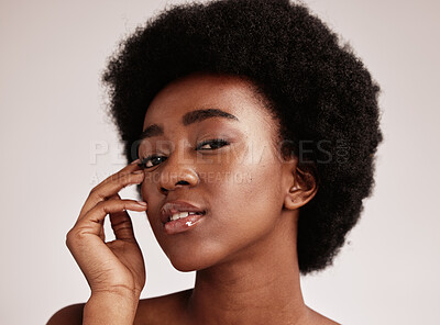 Buy stock photo Portrait, beauty or natural and a model black woman in studio on a gray background with afro hair. Skin, cosmetics and skincare with an attractive young female posing indoor for health or wellness
