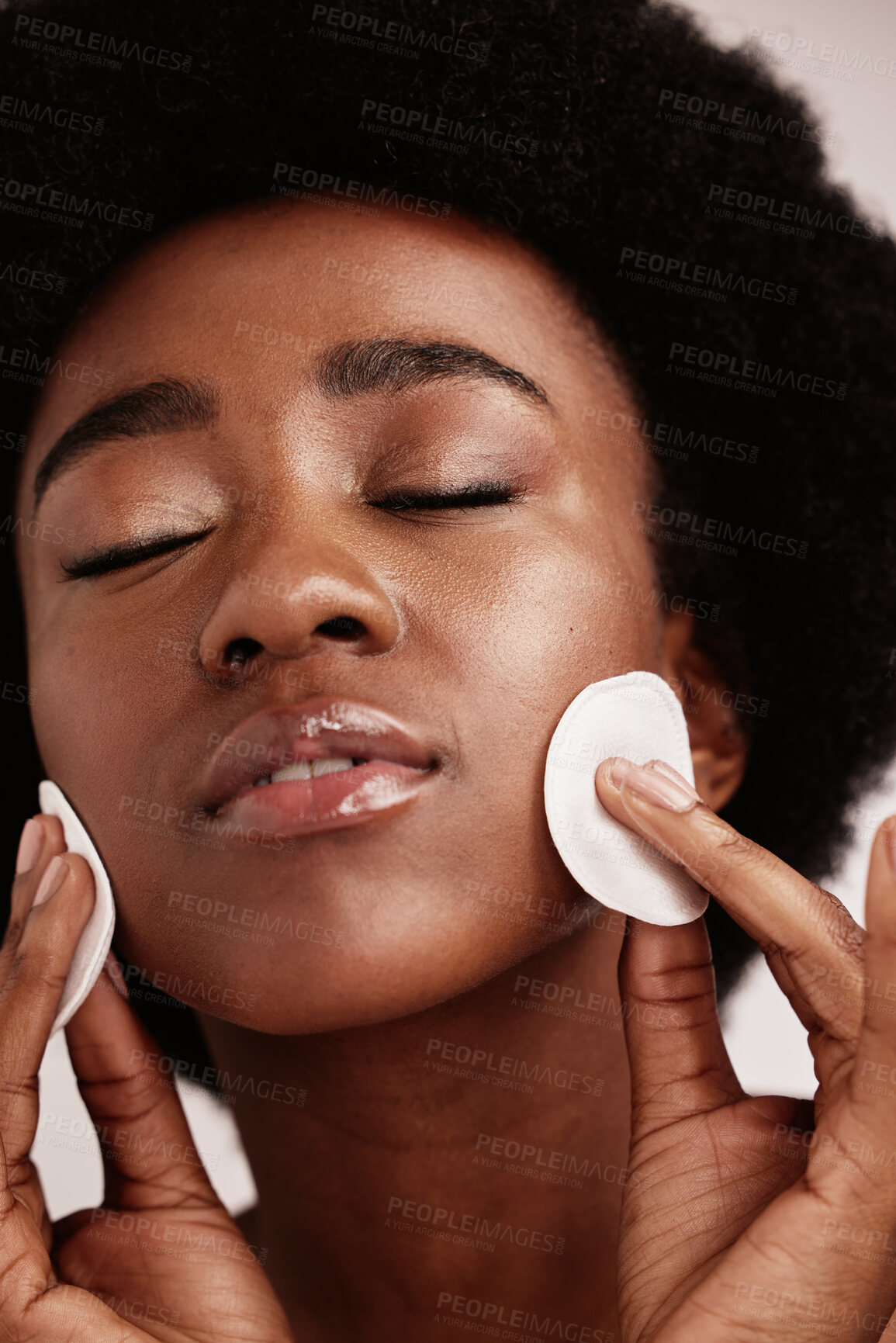 Buy stock photo Cleaning face, skin care and cotton for black woman in studio with dermatology, cosmetics and detox. Aesthetic model with hands on natural facial skin to clean makeup, beauty and wellness for spa