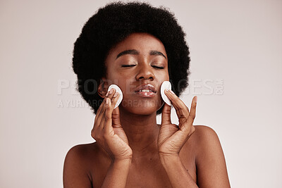 Buy stock photo Skin care, cotton and cleaning face of black woman in studio with dermatology, cosmetic and detox. Aesthetic model with hands on natural facial skin for makeup remover, beauty and wellness for spa
