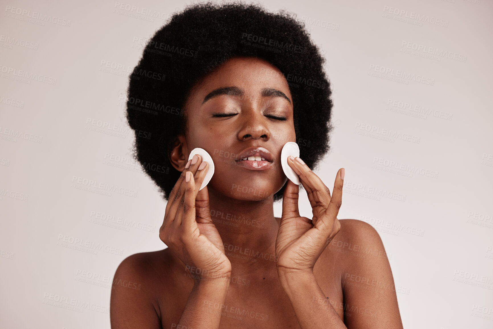 Buy stock photo Skin care, cotton and cleaning face of black woman in studio with dermatology, cosmetic and detox. Aesthetic model with hands on natural facial skin for makeup remover, beauty and wellness for spa