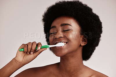 Buy stock photo Toothbrush, brushing teeth and black woman for clean and healthy mouth on studio background. Face of person advertising dentist tips for dental care, whitening and cleaning with a hygiene smile