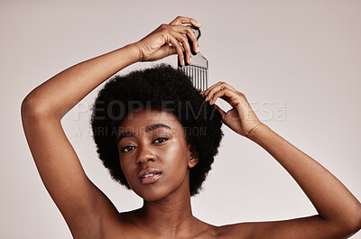 Buy stock photo Afro comb, black woman and portrait of a model with hair care, salon and cosmetics. Hairdresser comb, African hairstyle and beauty of a young person doing a treatment for self care in a studio