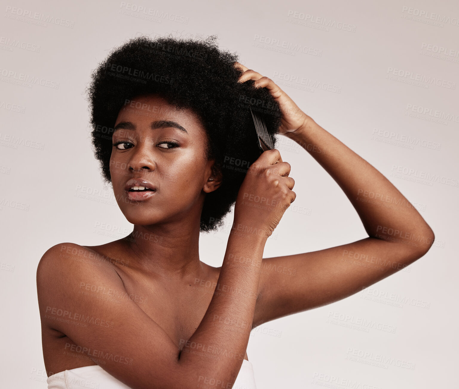 Buy stock photo Afro hair comb, black woman and face of a model with care, salon and cosmetics. Hairdresser, African hairstyle and beauty of a young person doing a treatment for self care in a isolated studio