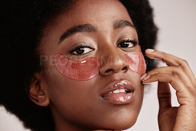 Buy stock photo Eye, skincare and face mask portrait on black woman in studio with dermatology cosmetic product. Aesthetic model with collagen patch for health, wellness and natural facial beauty on grey background