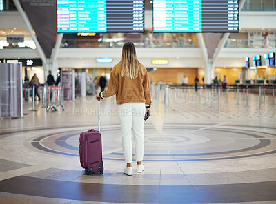 Buy stock photo Woman, airport and luggage checking flight times for travel, vacation or journey with passport in Cape Town. Female traveler standing and waiting ready for departure, boarding plane or immigration
