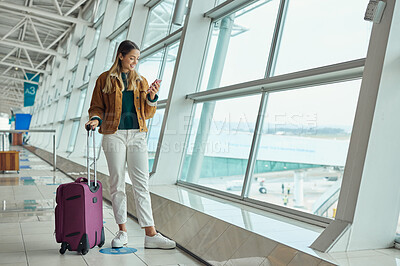 Buy stock photo Luggage, travel and woman with phone at airport for social media, web scrolling or internet browsing. Suitcase, mobile and happy female on smartphone for networking while waiting for flight departure