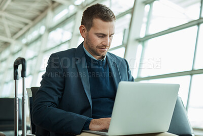 Buy stock photo Business man, airport and laptop for travel while working in lobby to check flight booking. Entrepreneur person with luggage in building while typing or writing email or report on trading investment