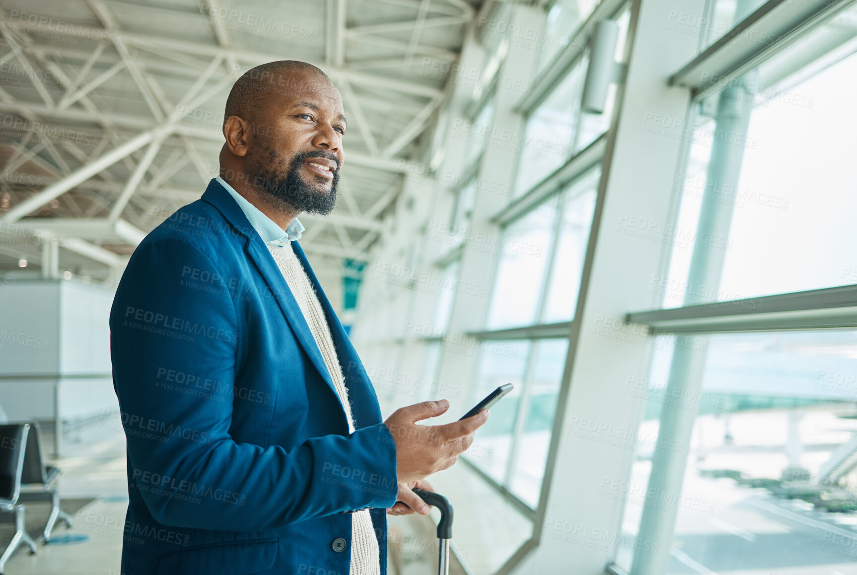 Buy stock photo Black man, phone and thinking at airport window for business travel, trip or communication waiting for flight. African American male with smile contemplating schedule or plain times on smartphone