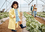 Kid, happy or girl in farming portrait, akimbo or hands on hips in greenhouse, agriculture land or sustainability field pride. Smile, child or learning gardening in countryside nature or lettuce agro