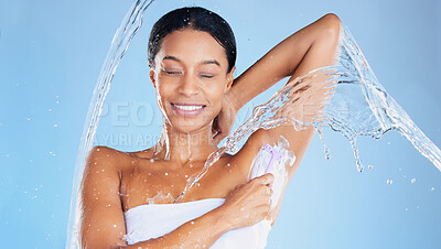 Buy stock photo Black woman, water splash or shaving underarms on blue background in relax grooming, body hair removal or healthcare wellness. Beauty model, happy or wet in armpit razor cream for skincare cleaning