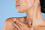 Beauty, water splash and showering in skincare grooming, healthcare wellness or sustainability cleaning on isolated blue background. Zoom, black woman and model in wet drops for hydration dermatology