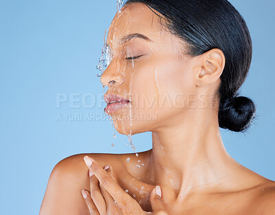 Buy stock photo Beauty, water splash or washing face in shower grooming, healthcare or sustainability cleaning on isolated blue background. Zoom, black woman or model in wet drops for skincare hydration dermatology