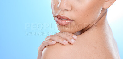 Buy stock photo Skincare, beauty and woman with hand on shoulder with zoom, blue background and mockup space. Health, dermatology and product placement, model in studio for healthy skin and wellness for body care.