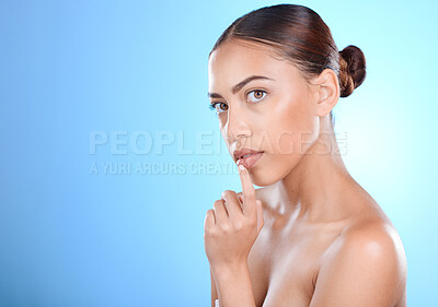 Buy stock photo Portrait, beauty and mock up with a model black woman in studio on a blue background for skincare. Face, skin and mockup with an attractive young female posing for natural treatment or cosmetics