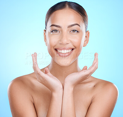 Buy stock photo Beauty, skincare and portrait of woman with smile on blue background for wellness, cosmetics and self care. Dermatology, luxury spa and hand and face of girl for makeup, glow and facial treatment