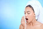 Shower, grooming and woman smelling breath for oral care isolated on blue background in a studio. Dental, healthcare and girl breathing into hand to check for odor problem on a mockup space backdrop