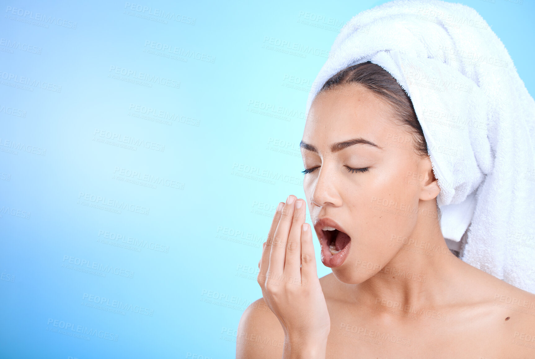 Buy stock photo Shower, grooming and woman smelling breath for oral care isolated on blue background in a studio. Dental, healthcare and girl breathing into hand to check for odor problem on a mockup space backdrop