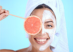 Skincare, portrait and woman with grapefruit mask in studio for beauty, hair and cosmetics on blue background, Face, facial and girl model relax in fruit, luxury and product, wellness or isolated