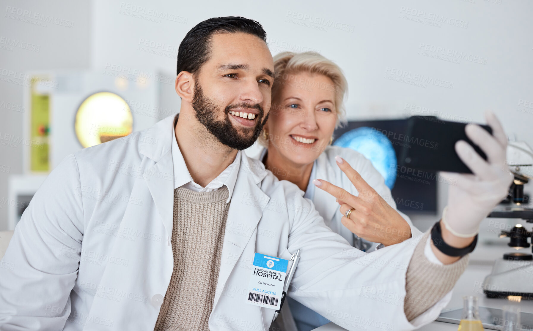 Buy stock photo Science team, selfie and smile in lab for research, peace sign and happy at pharma company with phone. Scientist man, woman and profile picture for app, social network and teamwork with happiness