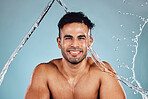 Water splash, portrait and skincare man isolated on blue background face cleaning, body shower and beauty. Fitness model or person in studio headshot for aesthetic, washing and dermatology hygiene