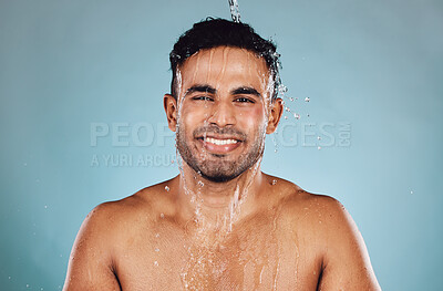 Buy stock photo Portrait, wet and man with water, cleaning and hygiene with guy on blue studio background. Face, male and gentleman with liquid, aqua or washing for skincare, morning routine or grooming on backdrop 