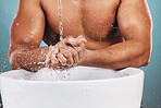 Man, water splash and hands by basin for skincare, hygiene or wash against studio background. Hand of young male model in beauty, wellness and washing or cleansing for body care and self love by sink