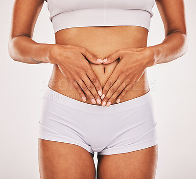 Buy stock photo Gut health, hands in heart and stomach of woman on white background for digestion, diet and weight loss. Fitness, body wellness and abdomen of girl for healthy lifestyle, tummy tuck and liposuction