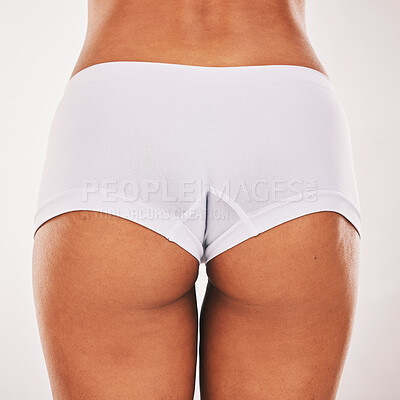 Buy stock photo Buttocks, underwear and closeup with a model black woman in studio on a gray background from the back. Skin, real and bum in panties with a normal female posing to promote natural body positivity