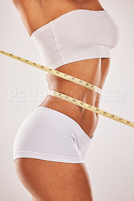 Buy stock photo Lose weight, body and woman with tape measure on stomach for diet, health and wellness. Healthy model studio background for fitness, goal and motivation in underwear for exercise results and progress