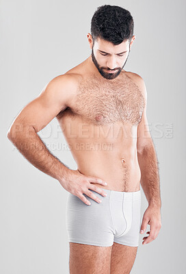 Buy stock photo Fitness, body and underwear with a man model in studio on a gray background for health or grooming. Aesthetic, muscle and manly with a handsome young male posing to promote wellness or lifestyle