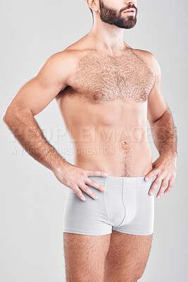 Buy stock photo Body, underwear and model with a man in studio on a gray background for health, fitness or wellness. Exercise, stomach and underpants with a male posing in studio to promote a healthy lifestyle
