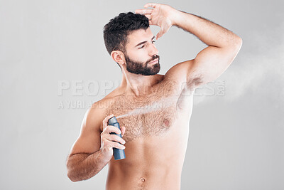 Buy stock photo Spray, deodorant and man with cosmetics, morning routine or grooming on grey studio background. Male, perfume or fragrance for fresh scent, self care or hygiene with guy or antiperspirant on backdrop
