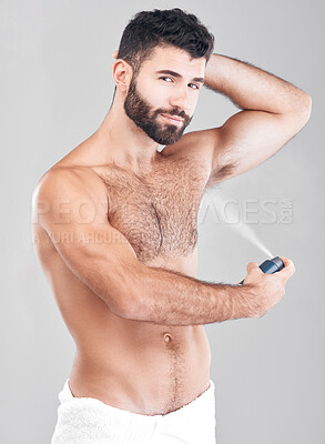 Buy stock photo Portrait, deodorant and man spray armpit for hygiene, fresh scent and grooming isolated on a gray studio background. Cosmetics, wellness and young male model with perfume, fragrance or antiperspirant