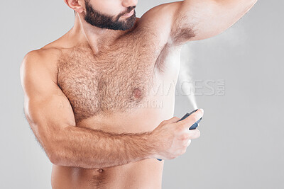 Buy stock photo Deodorant, spray and man in studio for hygiene, fresh scent or underarm perfume. Male model spraying armpit for body odor, smell and cleaning cosmetics, shower product and skincare mist on background