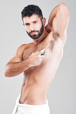 Buy stock photo Deodorant, spray and portrait of man in studio cleaning for hygiene, fresh scent or sweating smell. Male model spraying armpit for body odor, beauty cosmetics or skincare bottle product on background