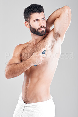 Buy stock photo Deodorant, spray and man in studio grooming for hygiene, fresh scent or sweating smell. Male model spraying armpit of body odor, beauty cosmetics and cleaning skincare of bottle product on background