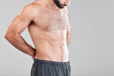 Buy stock photo Insecurity, shirtless and man looking at body while isolated on grey studio background with mockup. Fitness, abs and topless model insecure about weight, stomach and waistline with space on backdrop
