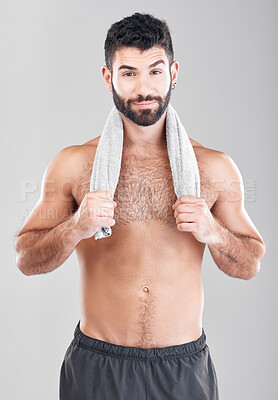 Health, fitness and man with towel on neck after sports workout, sweat and hygiene isolated on grey background. Portrait of coach, personal trainer and smile, body care mindset for exercise in studio