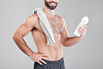 Fitness, exercise and man with water bottle, towel and workout for wellness, healthy lifestyle and grey studio background. Male, athlete or liquid for after training, practice or endurance for energy