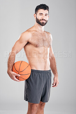 Sport, fitness and portrait of man with basketball and smile, topless and isolated on grey background. Exercise, motivation and ball sports coach or personal trainer with workout mindset in studio.
