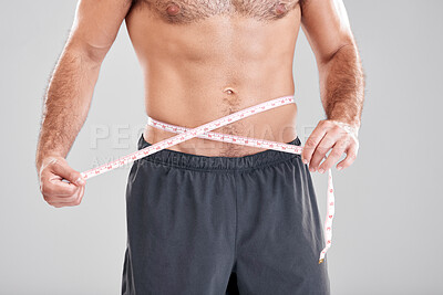 Buy stock photo Fitness, weightloss and man with measuring tape on waist, healthy diet and exercise in body care. Sports, nutrition and stomach, tracking weight loss and six pack progress isolated on grey background