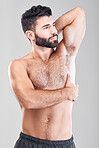Beauty, body and underarm with a man model in studio on a gray background for health or wellness. Skin, chest and muscle with a handsome young male standing indoor to promote a health lifestyle