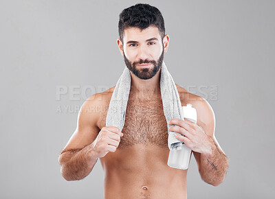 Buy stock photo Portrait, man and skincare for water bottle, towel and hygiene after training, shower and guy on grey studio background. Mockup, male and gentleman with cosmetics, confident and grooming for wellness