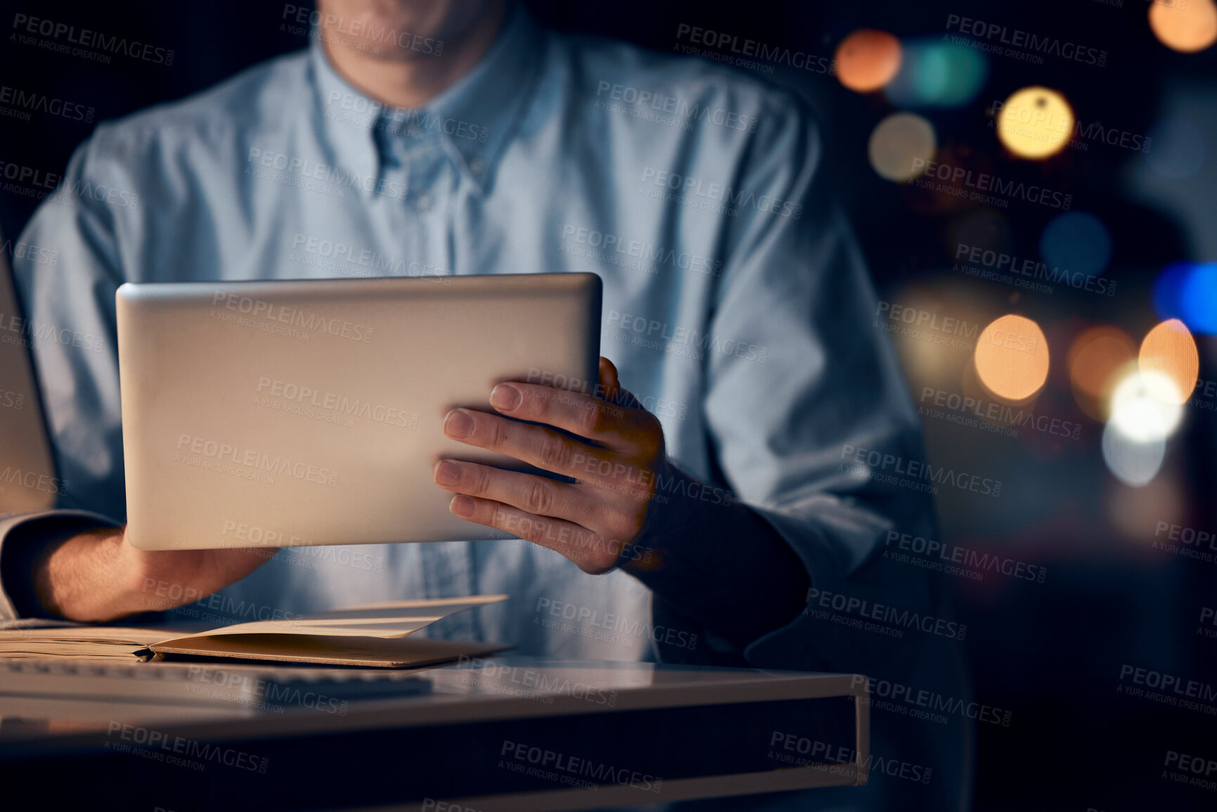 Buy stock photo Hands, tablet and business man in office working late on project, email or research at night. Bokeh, technology and male employee with digital touchscreen for networking, social media or web browsing