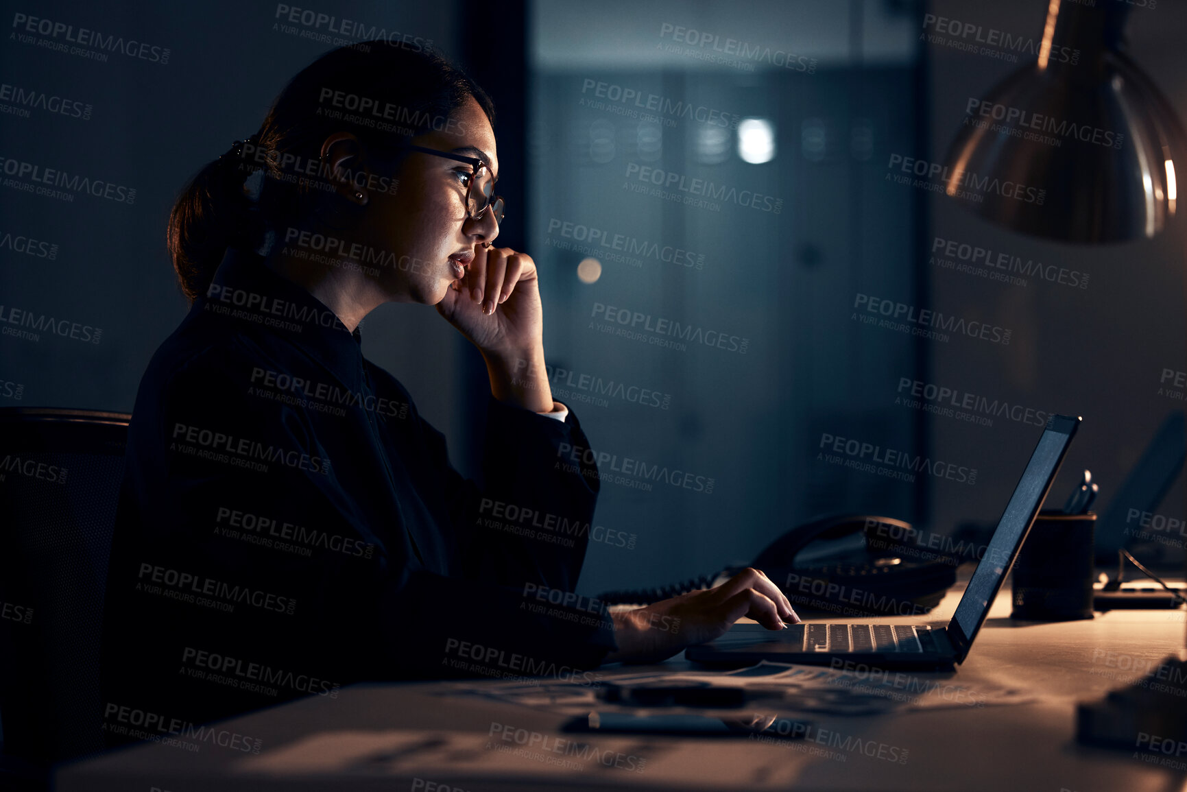 Buy stock photo Serious woman, night business and laptop for planning, research and strategy in dark startup office. Female working overtime on computer technology, online website and network at table for analytics