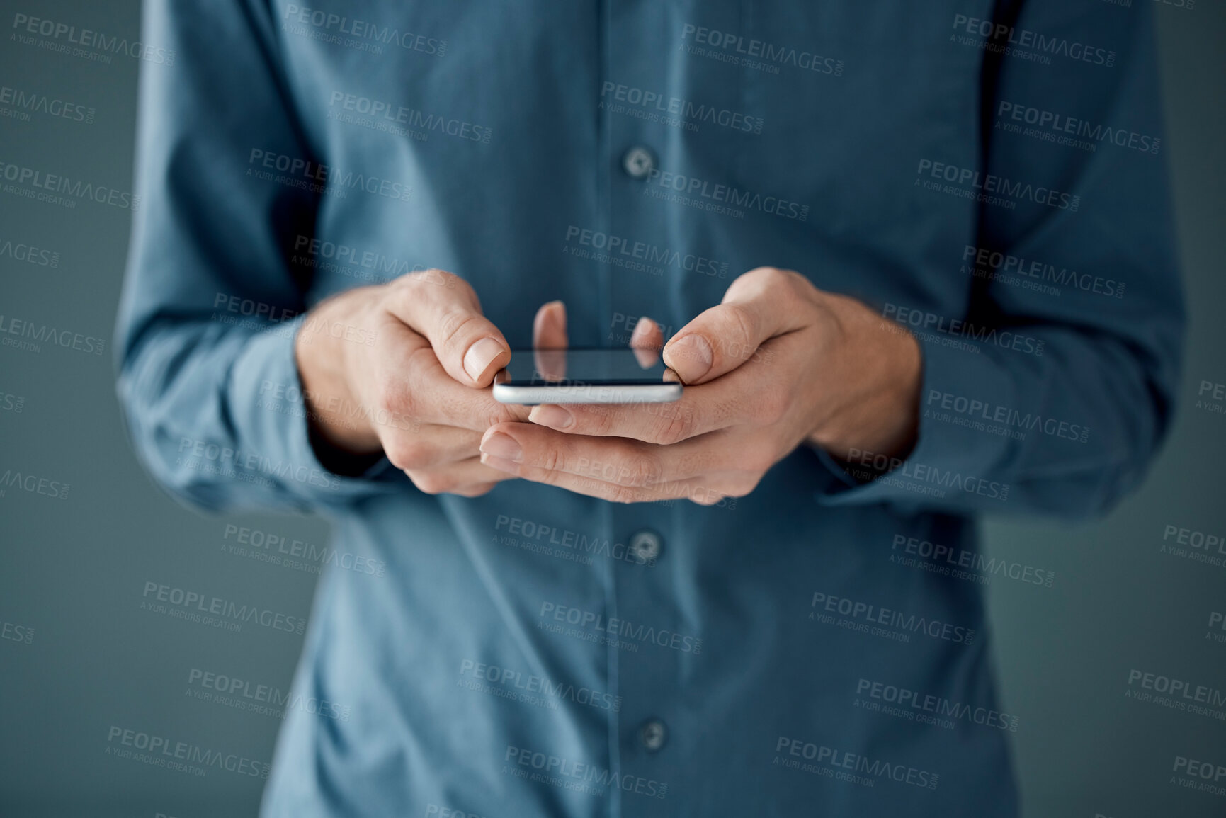 Buy stock photo Hands, phone and networking for social media, communication or digital marketing against a studio background. Hand of person holding mobile smartphone for online chatting, conversation or app 