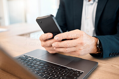 Buy stock photo Hands, phone and research with a business man typing a text message while working on his laptop. Mobile, communication and networking with a male manager or employee reading an email at work