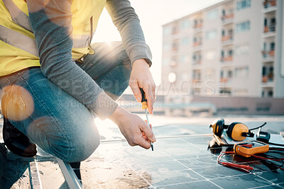 Buy stock photo Hands, solar energy and construction with a man in the city on a rooftop to install a panel for renewable power. Building, grid and electricity with a male handyman or contractor doing maintenance