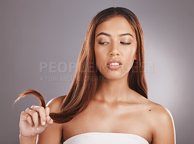 Buy stock photo Hair care, beauty salon and split ends of a black woman feeling annoyed from hairstyle. Shampoo, cosmetic and haircut of a young model with isolated gray background feeling angry in a studio